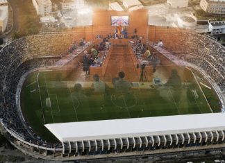 Futuro del Heliodoro: plan, retrasos y credibilidad Vista aérea del estadio Heliodoro Rodríguez López con la imagen difuminada del pleno del Cabildo de Tenerife superpuesta sobre el terreno de juego.
