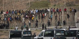 Devoluciones masivas en Ceuta: los límites de la ley Migrantes junto a la valla fronteriza de Ceuta bajo vigilancia de la Guardia Civil durante una situación de fuerte presión migratoria.