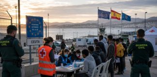 Política migratoria democrática: la salida para Ceuta Frontera de Ceuta con agentes de la Guardia Civil y personal humanitario atendiendo e identificando a personas migrantes junto al puerto.